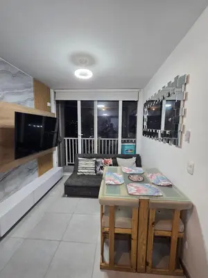 a living room with a table and a couch at brisa y sol - sunset 47 in Cartagena de Indias
