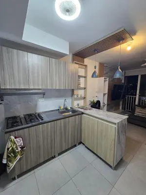 a kitchen with wooden cabinets and a sink and a stove at brisa y sol - sunset 47 in Cartagena de Indias