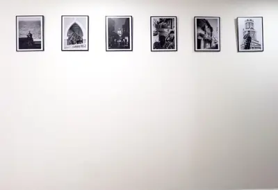 a row of photos on a wall at 3 Cuartos 2 balcones in Cartagena de Indias