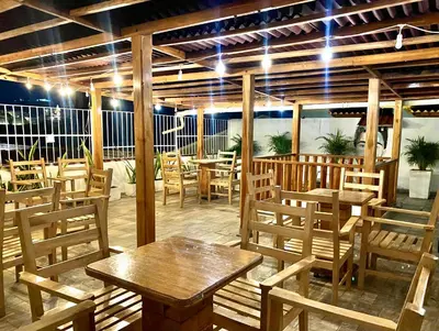 a restaurant with wooden tables and chairs with lights at Hotel Casa Lopez - Cartagena in Cartagena de Indias
