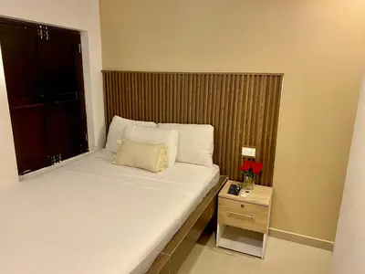 a small bedroom with a bed and a window at Hotel Casa Lopez - Cartagena in Cartagena de Indias