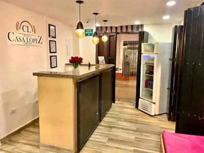 a kitchen with a counter and a refrigerator at Hotel Casa Lopez - Cartagena in Cartagena de Indias