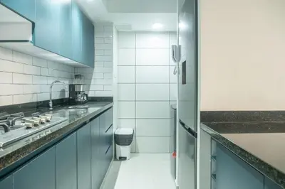 a kitchen with blue cabinets and a sink at Torre 811 By Jalo in Cartagena de Indias