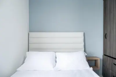 a bedroom with a bed with white sheets at Torre 811 By Jalo in Cartagena de Indias