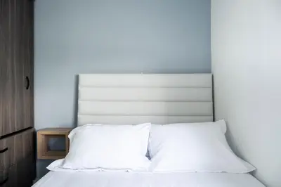 a white bed with a white headboard in a bedroom at Torre 811 By Jalo in Cartagena de Indias
