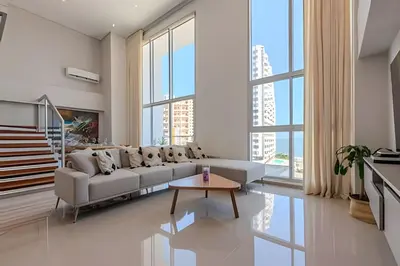 a living room with a couch and a table at Doble altura y lujoso apto vista al mar in Cartagena de Indias