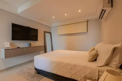 a bedroom with a bed and a flat screen tv at Doble altura y lujoso apto vista al mar in Cartagena de Indias