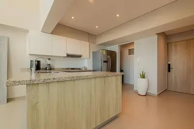a kitchen with white cabinets and a counter top at Doble altura y lujoso apto vista al mar in Cartagena de Indias