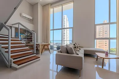 a living room with a staircase and a couch at Doble altura y lujoso apto vista al mar in Cartagena de Indias