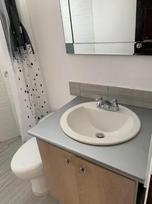 a bathroom with a sink and a toilet and a mirror at Cabaña 5 - Conjunto frente al mar con piscina in Coveñas