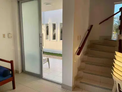 a glass door leading into aoyer with a staircase at Cabaña 5 - Conjunto frente al mar con piscina in Coveñas