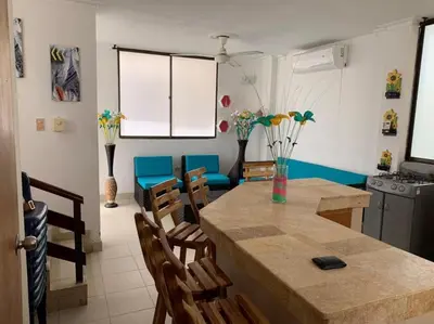 a kitchen and dining room with a table and chairs at Cabaña 5 - Conjunto frente al mar con piscina in Coveñas