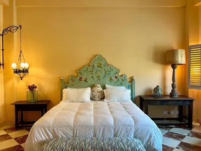 a bedroom with a large bed and two night stands at Apto cuesta 203 in Cartagena de Indias