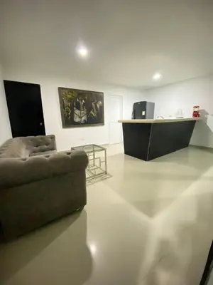 a living room with a couch and a table at Cómodo & Económico Apartamento para 4 pax en La Boquilla in Cartagena de Indias