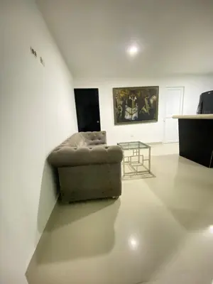 a living room with a couch and a table at Cómodo & Económico Apartamento para 4 pax en La Boquilla in Cartagena de Indias
