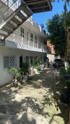 a building with a lot of plants in front of it at Cómodo & Económico Apartamento para 4 pax en La Boquilla in Cartagena de Indias