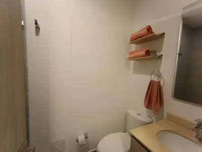 a bathroom with a toilet and a sink and a mirror at Apartamento Santa Marta Sector Don Jaca in Simón Bolivar