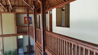 a staircase in a house with wooden railing at Beach House la Tortuga, Punta Seca, Rincón del Mar