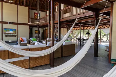 a hammock in the lobby of a resort at Beach House la Tortuga, Punta Seca, Rincón del Mar