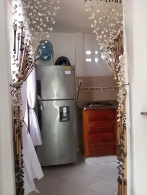 a kitchen with a stainless steel refrigerator and a counter at Cabaña el cielo in Lorica