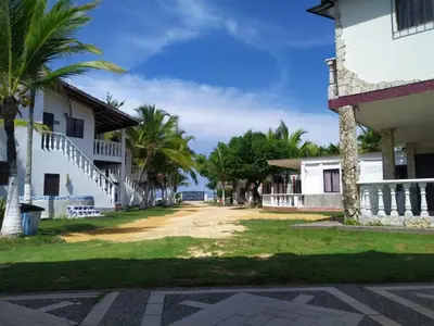 a street in front of a building with palm trees at Cabaña el cielo in Lorica