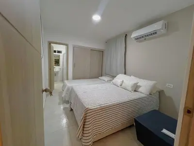 a bedroom with two beds and a air conditioner at New house in Barranquilla in Barranquilla