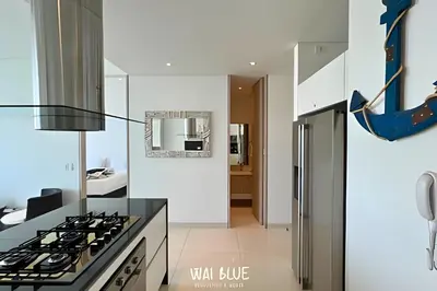 a kitchen with a stove and a refrigerator at Wai Blue/Luxury Beachfront/ Bello Horizonte/ TTO03 in Playa Dormida