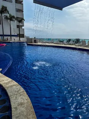 a swimming pool in front of a building at Piso 30 vista al mar, Palmetto 1 Bocagrande in Cartagena de Indias