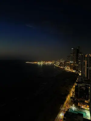 a view of a beach at night with a city at Piso 30 vista al mar, Palmetto 1 Bocagrande in Cartagena de Indias