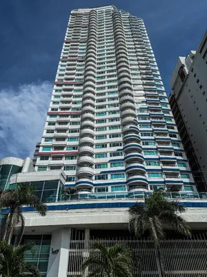 a tall building with palm trees in front of it at Piso 30 vista al mar, Palmetto 1 Bocagrande in Cartagena de Indias
