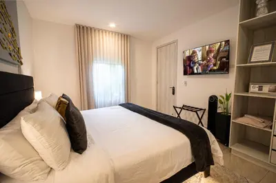 a bedroom with a white bed and a window at The Villa Catalina in Cartagena de Indias