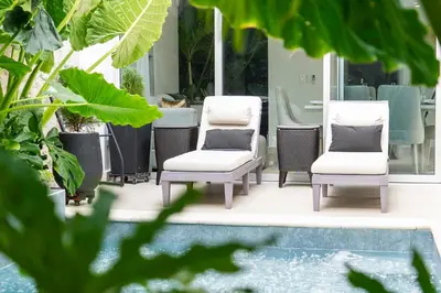 two chairs sitting on a porch next to a pool at The Villa Catalina in Cartagena de Indias