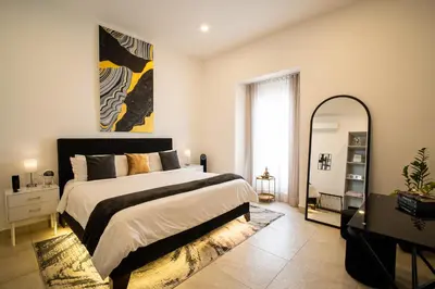 a bedroom with a large bed and a mirror at The Villa Catalina in Cartagena de Indias