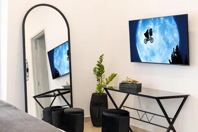 a room with a mirror and a table and a mirror at The Villa Catalina in Cartagena de Indias