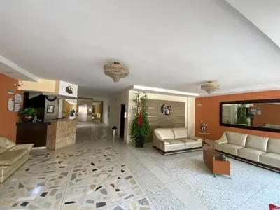 a large living room with couches and a living room at Hotel San Francisco in Barranquilla