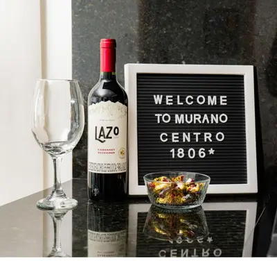 a bottle of wine and a glass and a bottle of wine at Modern Sunset Stay Cartagena in Cartagena de Indias