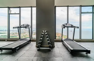 a gym with two treadmills in front of windows at Modern Sunset Stay Cartagena in Cartagena de Indias