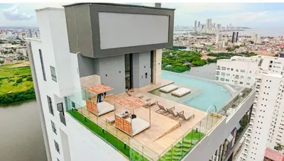 a building with a swimming pool on top of it at Modern Sunset Stay Cartagena in Cartagena de Indias