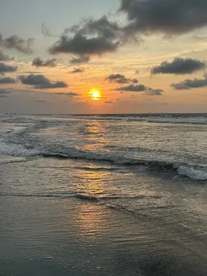 a sunset on the beach with the ocean at 302 Apartamento frente al mar in San Bernardo del Viento