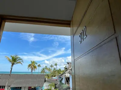 a building with a view of the ocean and palm trees at 302 Apartamento frente al mar in San Bernardo del Viento