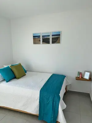 a bed in a white room with a window at 302 Apartamento frente al mar in San Bernardo del Viento