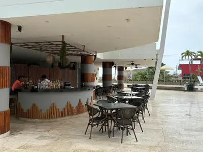 a restaurant with tables and chairs and a bar at Apartamento en Cartagena a pasos de la Playa in Cartagena de Indias