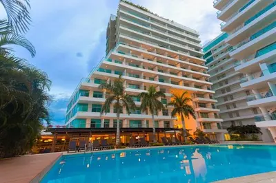 a large hotel with a swimming pool in front of a building at Apartamento en Cartagena a pasos de la Playa in Cartagena de Indias