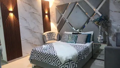 a bedroom with a bed with a black and white comforter at Hotel Portolindo in Barranquilla