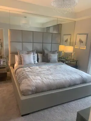 a large bed with a large headboard in a bedroom at Hotel Portolindo in Barranquilla