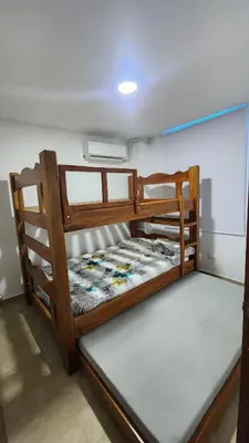 a wooden bunk bed sitting in a room at Cabaña brisa de mar in San Silvestre