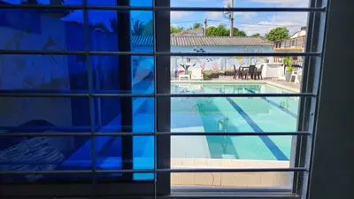 a view of a swimming pool through a window at Cabaña brisa de mar in San Silvestre