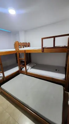 a room with two bunk beds in a room at Cabaña brisa de mar in San Silvestre