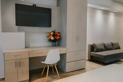 a room with a desk with a tv and a chair at Suite Frente al Mar en Cartagena 1410 in Cartagena de Indias