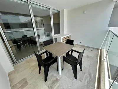 a dining room with a table and black chairs at Apartamento Moderno en Cartagena 1546 in Cartagena de Indias